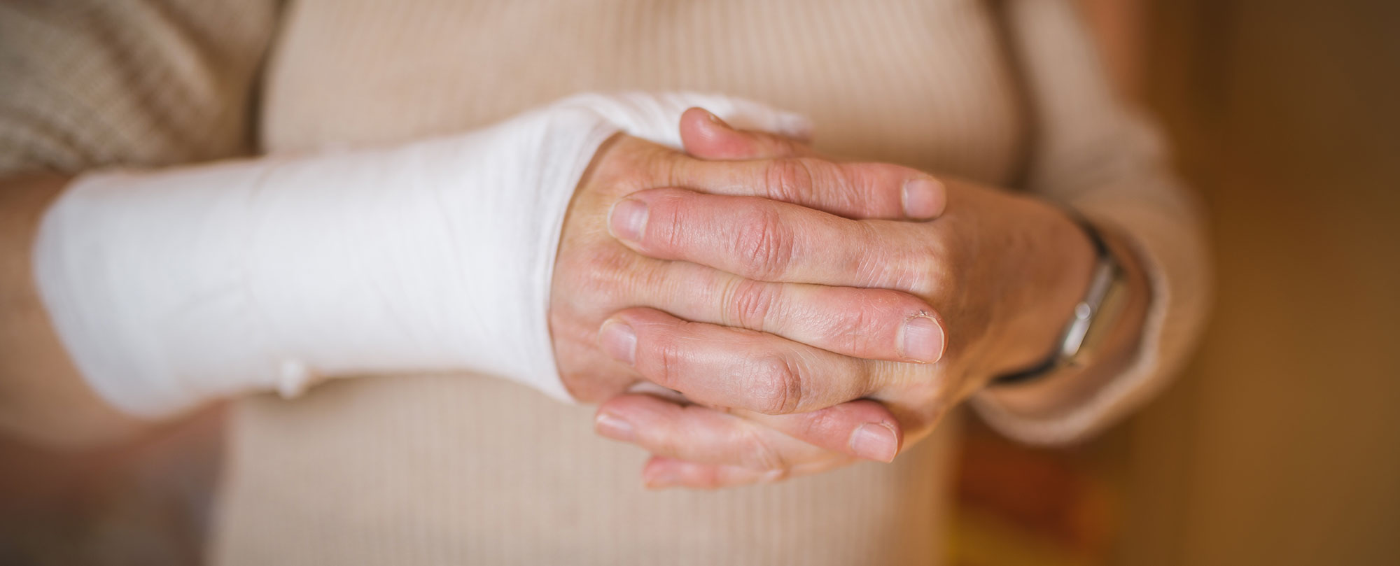older person with arm bandaged from an accident injury